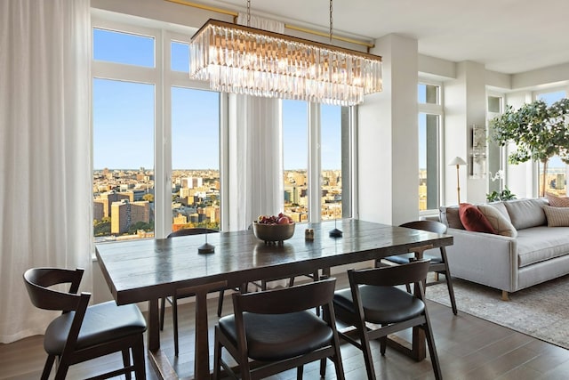 dining area featuring an inviting chandelier and dark wood-style flooring