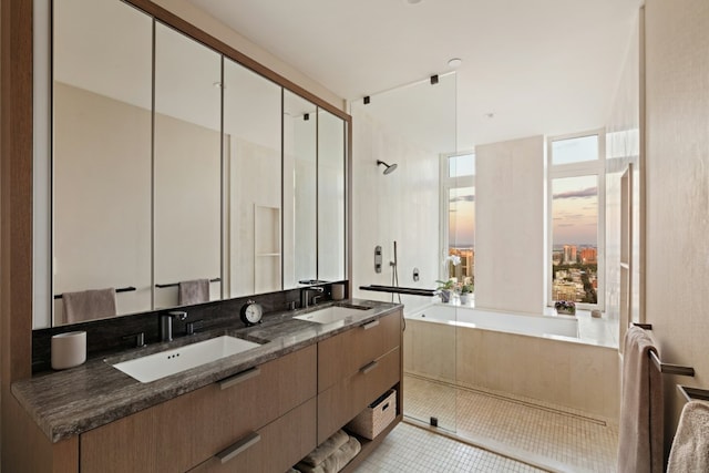 full bathroom featuring double vanity, tile patterned flooring, a sink, and a shower stall