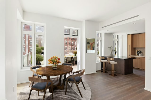 dining area featuring dark wood-style floors and baseboards