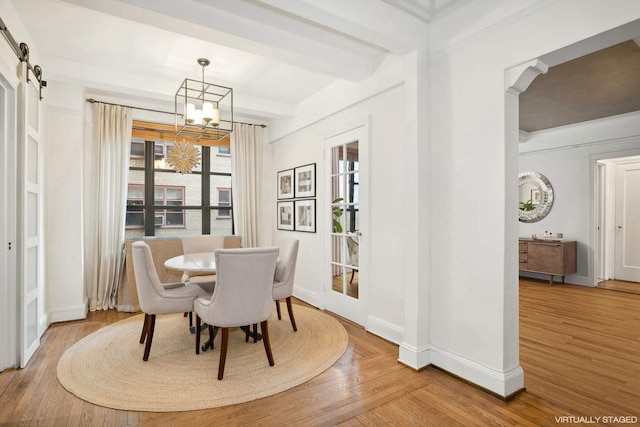 living room featuring beam ceiling, a fireplace, and hardwood / wood-style flooring