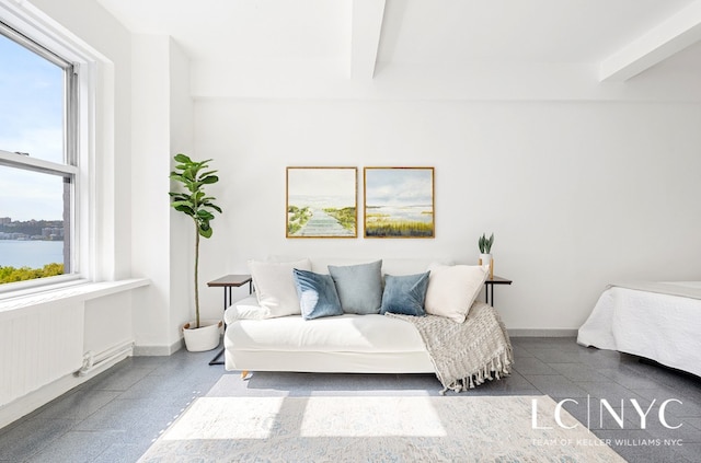 interior space featuring beamed ceiling and baseboards