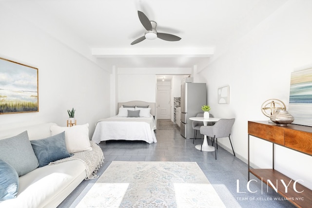 bedroom featuring a ceiling fan, freestanding refrigerator, beamed ceiling, and baseboards