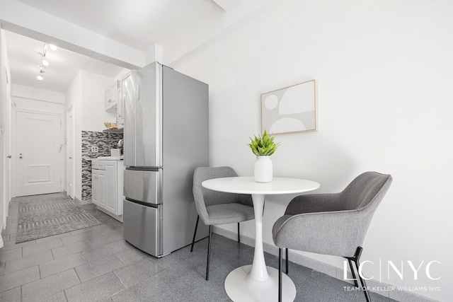 dining space with breakfast area and track lighting