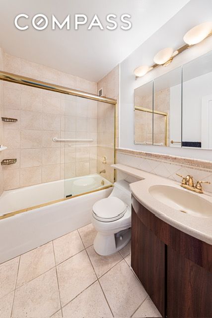 full bathroom with decorative backsplash, toilet, tile patterned flooring, bathtub / shower combination, and vanity