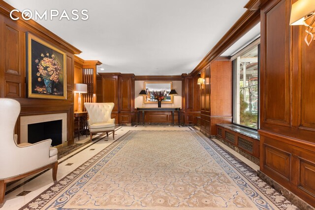 sitting room featuring a fireplace and ornamental molding