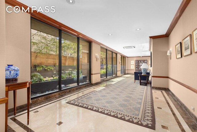 137 E 36th St Unit 6G, New York City, NY 10016 - community lobby featuring ornamental molding, recessed lighting, and a wall of windows