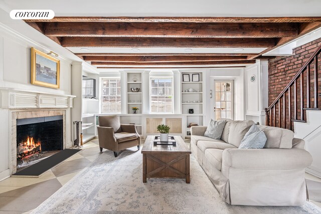 living area with beam ceiling, stairway, a fireplace with flush hearth, and visible vents