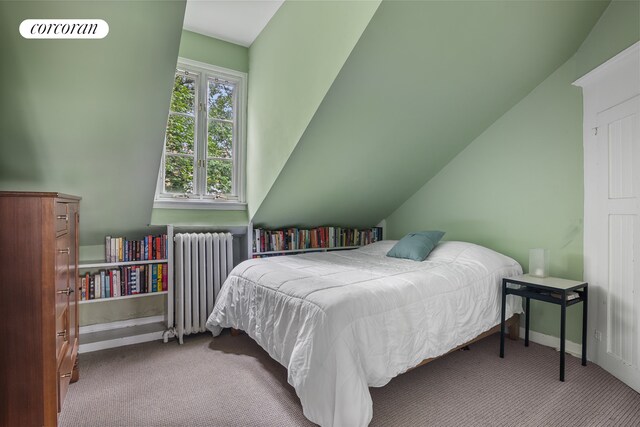 bedroom featuring carpet floors, lofted ceiling, radiator, and baseboards