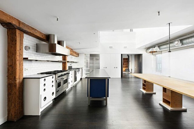 living room featuring beam ceiling and dark wood-type flooring