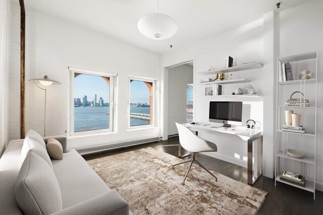 bedroom with a baseboard heating unit and hardwood / wood-style floors