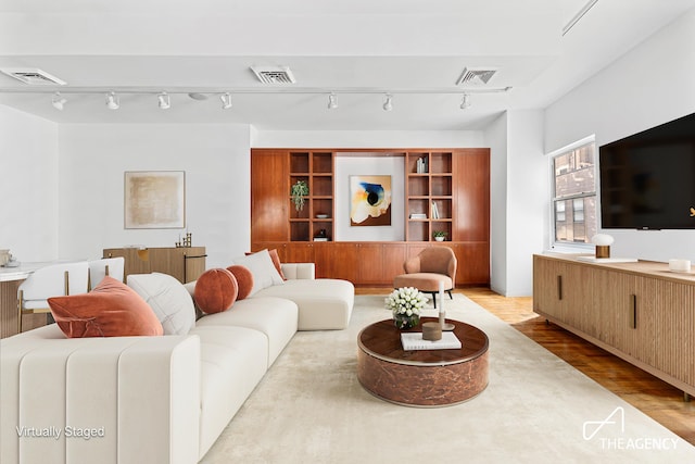 living room with visible vents and wood finished floors