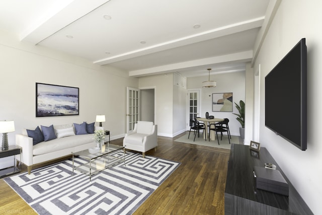 living room featuring beamed ceiling, dark hardwood / wood-style floors, and french doors