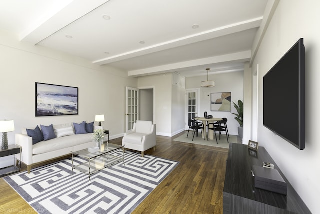 living area featuring dark wood-style floors, beamed ceiling, and baseboards