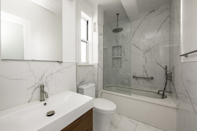 full bath featuring marble finish floor, toilet, a combined bath / shower with rainfall shower, and vanity