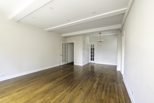 empty room featuring baseboards, wood finished floors, beam ceiling, and french doors