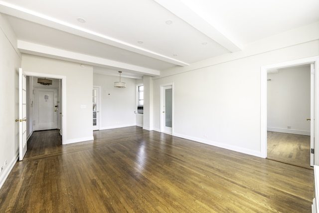 unfurnished living room with baseboards, wood finished floors, and beam ceiling