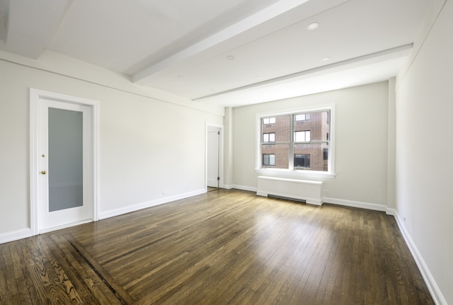 empty room featuring dark wood-style flooring, radiator, baseboards, and beamed ceiling