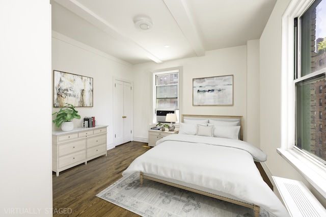 bedroom featuring beam ceiling, dark wood-style floors, and baseboards