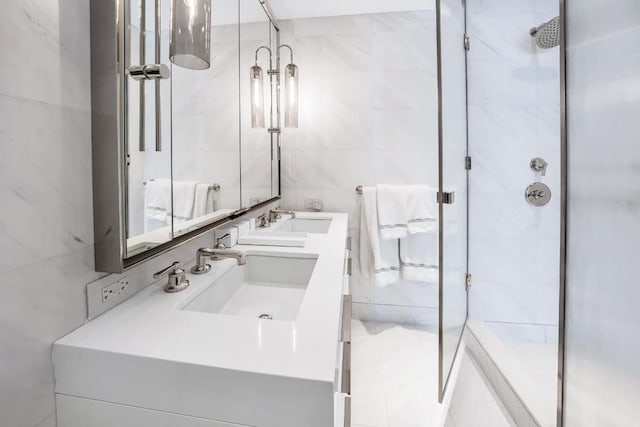 bathroom with an enclosed shower, vanity, and tile walls