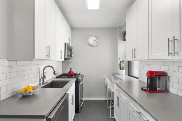 kitchen with sink, white cabinetry, and stainless steel appliances