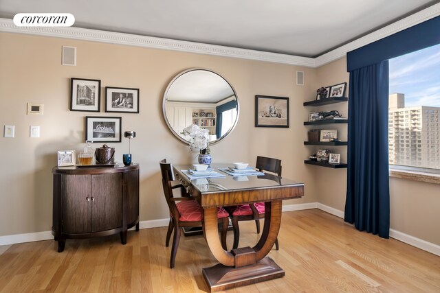 living room featuring hardwood / wood-style flooring, ornamental molding, and bar area