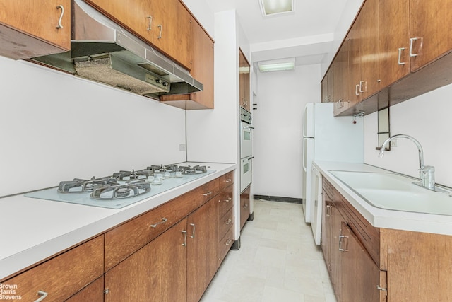 kitchen with sink and white appliances