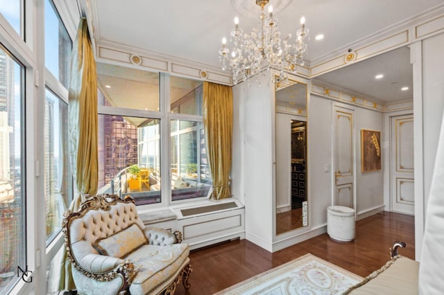 interior space featuring a notable chandelier, wood finished floors, and crown molding