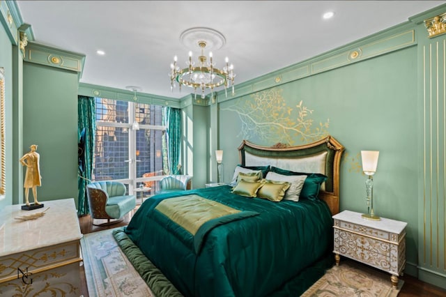 bedroom featuring a notable chandelier, wood finished floors, recessed lighting, and an accent wall