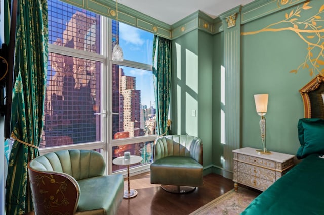 bedroom with wood finished floors and a city view