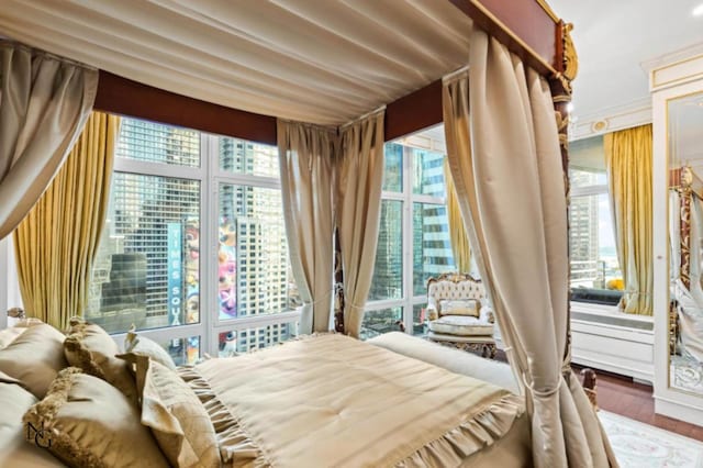 bedroom featuring hardwood / wood-style floors and expansive windows