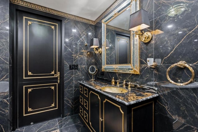 bathroom with vanity and tile walls