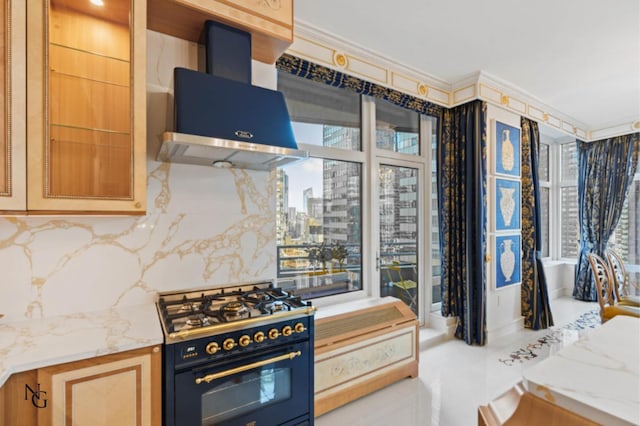 kitchen featuring decorative backsplash, a city view, light stone countertops, extractor fan, and gas range