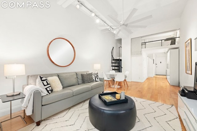 living room featuring ceiling fan, light wood-type flooring, and track lighting