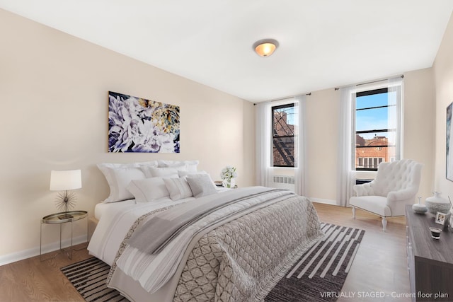 bedroom featuring wood finished floors and baseboards