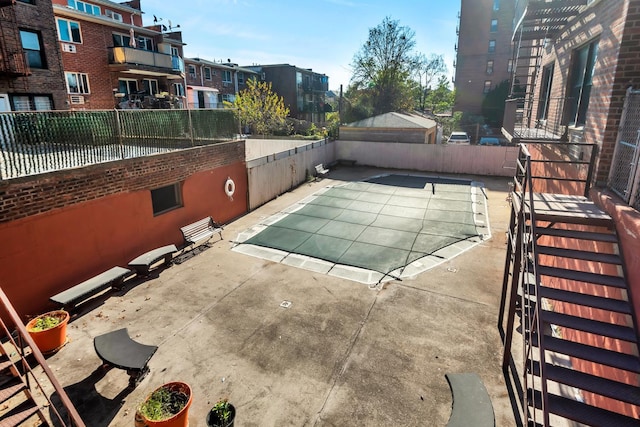 view of swimming pool featuring fence