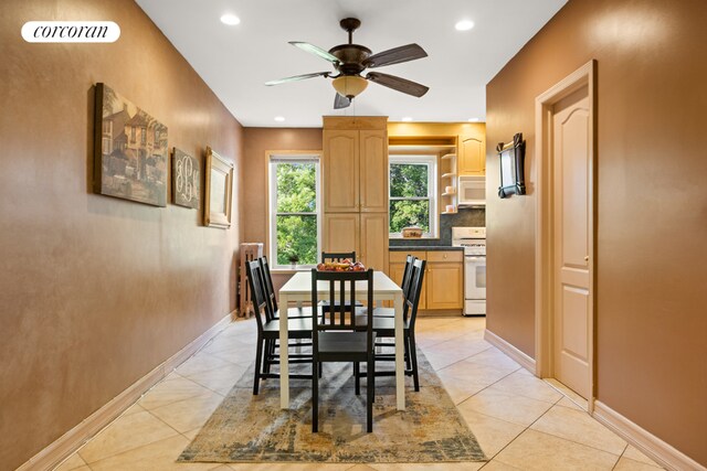 tiled living room featuring ceiling fan