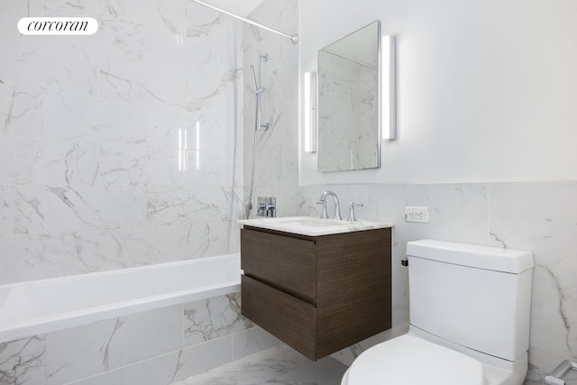 full bath with toilet, vanity, a combined bath / shower with marble appearance, marble finish floor, and tile walls