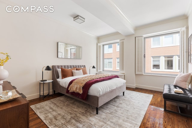 bedroom featuring baseboards, crown molding, and dark wood-type flooring