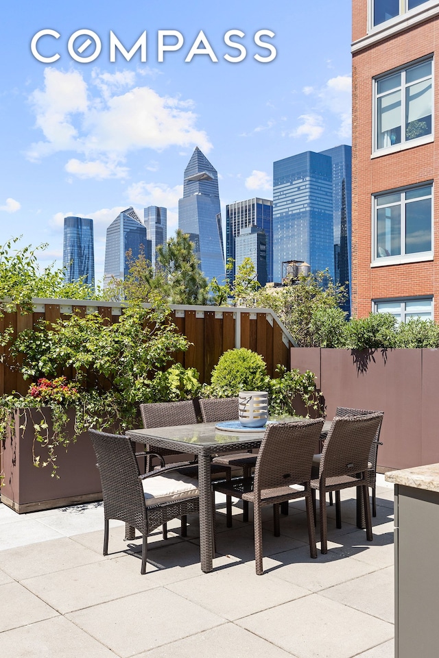 view of patio / terrace with a city view and outdoor dining space