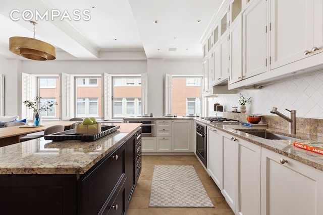 kitchen with white cabinetry, plenty of natural light, and stainless steel appliances