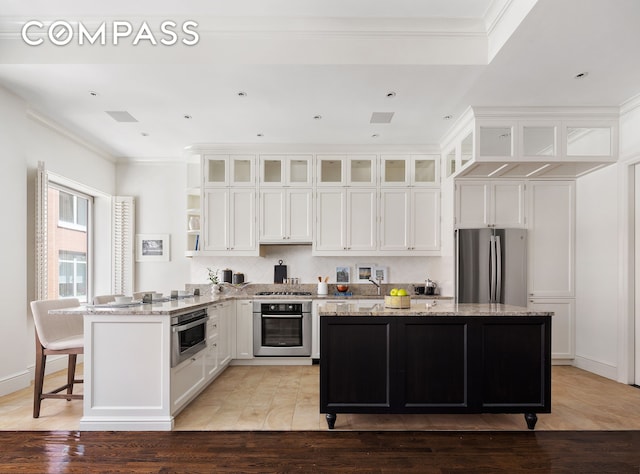 kitchen featuring open shelves, appliances with stainless steel finishes, ornamental molding, and white cabinetry