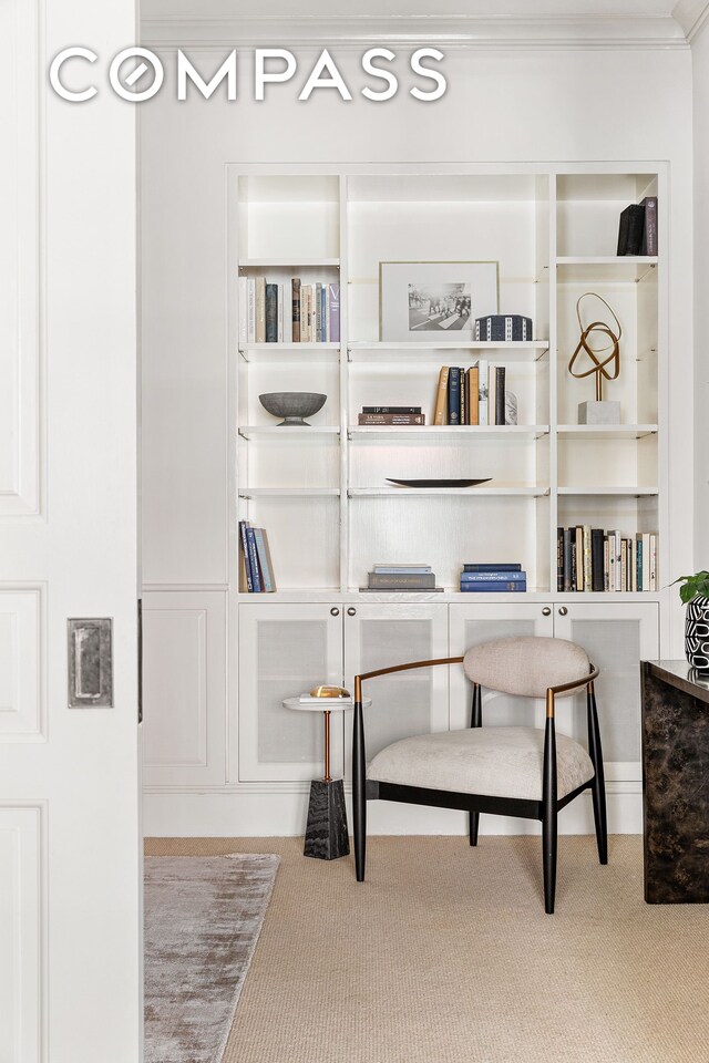 office with ornamental molding, light wood-type flooring, and built in shelves