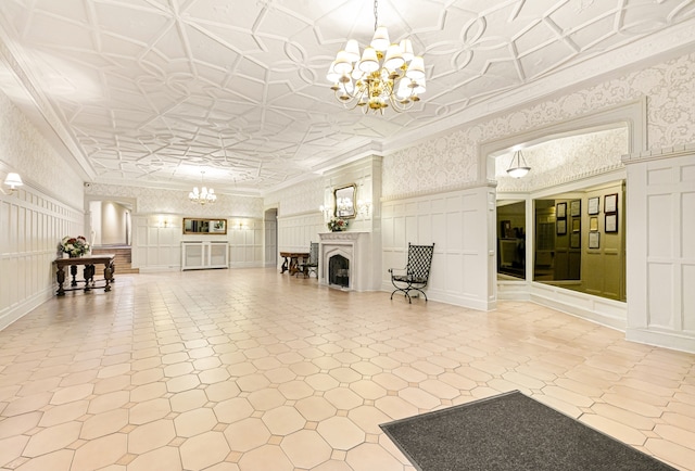 community lobby with a decorative wall, a wainscoted wall, and crown molding