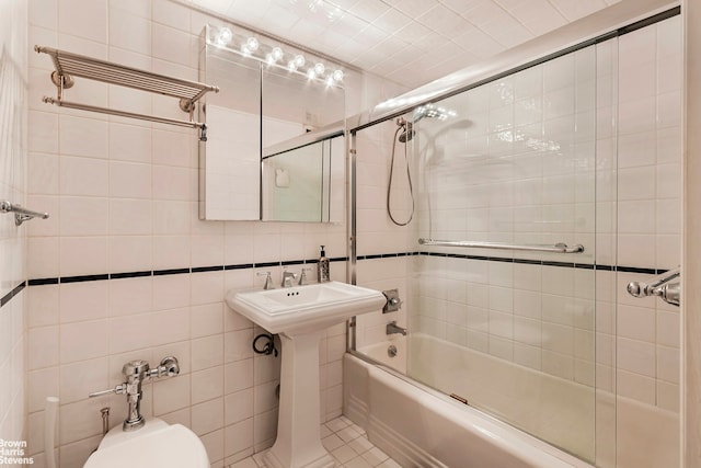 full bathroom featuring a sink, tile walls, toilet, and enclosed tub / shower combo