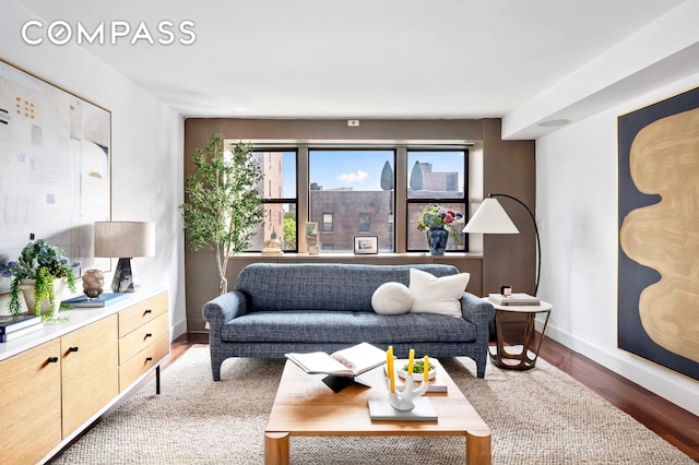 living room featuring baseboards and wood finished floors