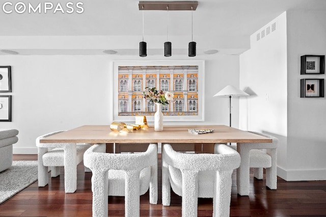 dining area featuring dark wood-type flooring