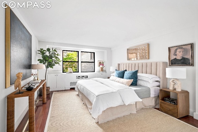 bedroom featuring hardwood / wood-style floors and radiator heating unit