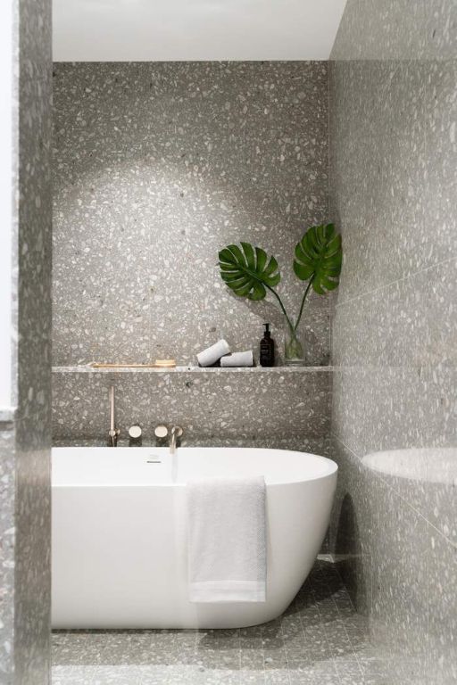 bathroom with tile patterned floors and a tub