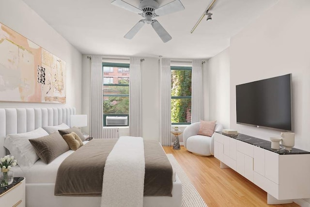 living room featuring light wood-type flooring, ceiling fan, and sink