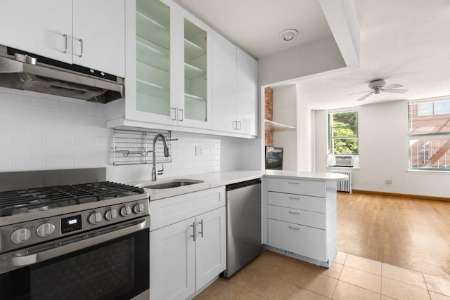 kitchen with white cabinets, dishwasher, gas stove, tasteful backsplash, and sink